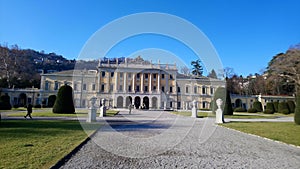 Old green garden in front of villa Olmo with statues, mountains view, lake como Italy photo