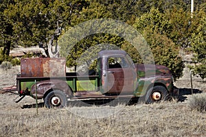 Old green pickup truck on ranch