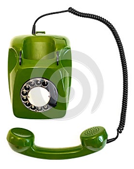 Old green rotary telephone on a white background