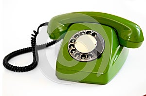 Old green rotary telephone on a white background