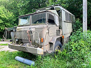 Old green truck parked on the grass