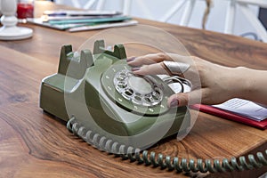 Old green vintage telephone on the table