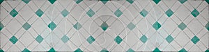 Old green white vintage shabby patchwork mosaic tiles wallpaper stone concrete cement wall texture background banner, with rhombus