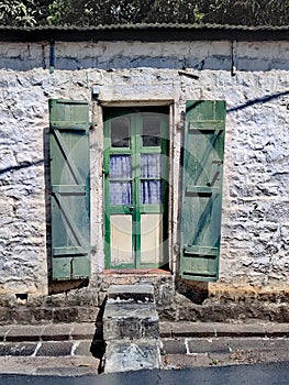 Old green wooden door in the capital of Mauritius Port Louis.