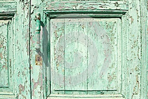 Old green wooden door with handle and lock