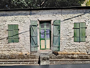 Old green wooden door and windows in the capital of Mauritius Port Louis.