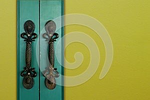Old green wooden entrance door with antique door handle