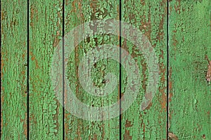 Old green wooden fence. Seamless texture. Green background. Old painted vertical boards