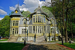 Old green wooden house in skansen. Open-air Museum - Wooden Architecture . Central Museum of Textiles