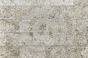 Old grey granite stone wall background texture