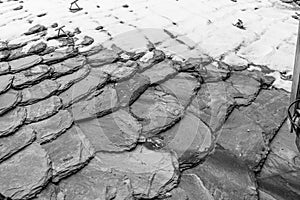 Old grey roof tiles covered with snow