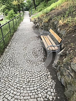Old grey stone road and wooden bench