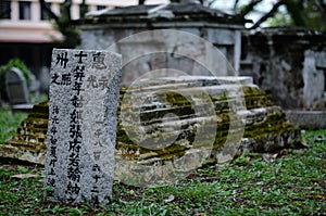 Old grey tombstones. Cemetery in Malaysia