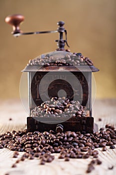 Old grinder with coffee beans