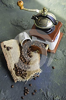 Old grinder and coffee beans dark background