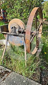 Old grindstone, in front of barn