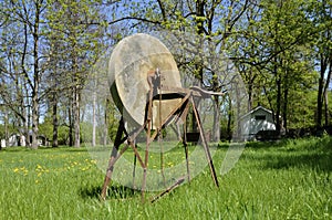 Old grindstone on the grass photo
