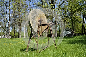 Old grindstone on the grass