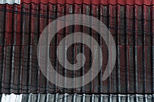 Old grunge red black roof of house texture with electric line wire background