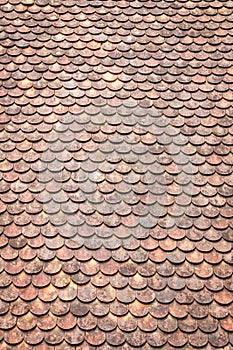 Old grunge red and orange weathered roof tiles texture background.