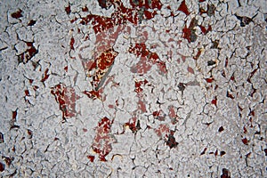 Old grunge texture of cracked red and white paint.