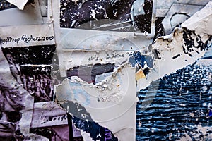 Old grunge torn collage posters creased crumpled paper placard texture background. Ripped faded paper backdrop surface