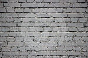 Old grunge vintage brick wall painted into solid gray background texture