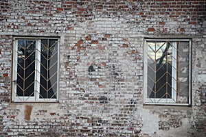 Old grunge wall and two windows. Fragment of old house. real estate concept