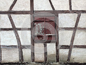 Old grunge wooden shutter window on a french rural house