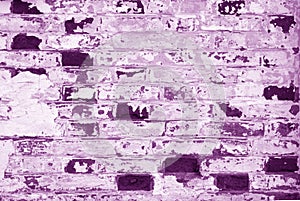 Old grungy brick wall texture with blur effect in purple tone