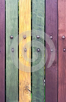 Old grungy Colorful fence with nails close up