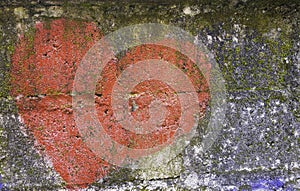 Old grungy concrete wall with painted heart as background or texture