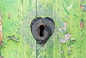 Old grungy green door and rusted lock