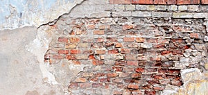 Old grungy red brick wall with peeled white beige stucco background. Vintage retro plaster wall with dirty cracked