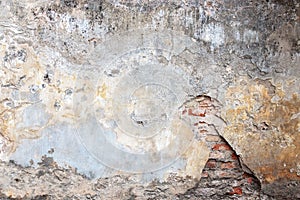 Old grungy red brick wall with peeled white beige stucco background. Vintage retro plaster wall with dirty cracked