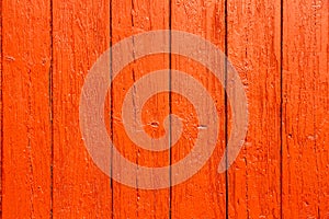 Old grungy and weathered red orange painted wooden wall plank simple texture background