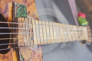 Old guitar on concrete wall background with blurred front and back background with bokeh effect