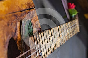 Old guitar on concrete wall background with blurred front and back background with bokeh effect