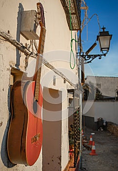 Old guitar hanging from the wall of a house,Granada,Andalucia,Spain