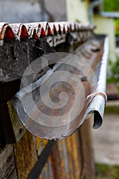 An old gutter in a detached house. Rainwater drainage from the roof