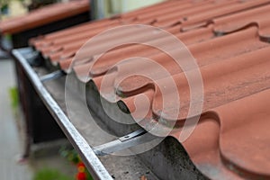 An old gutter in a detached house. Rainwater drainage from the roof