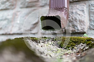 An old gutter in a detached house. Rainwater drainage from the roof