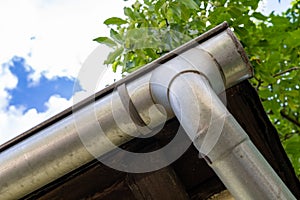 An old gutter in a detached house. Rainwater drainage from the roof