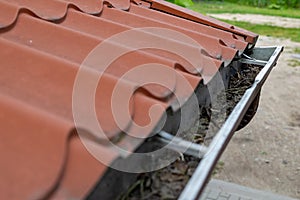 An old gutter in a detached house. Rainwater drainage from the roof