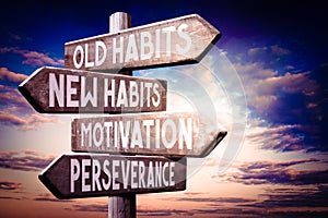 Old habits, new habits, motivation, perseverance - wooden signpost, roadsign with four arrows