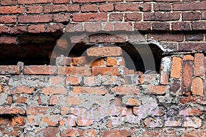 Old half destroyed stone wall of red bricks