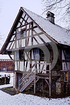 Old half-timbered house, historic peasant home, snowy winter season scene