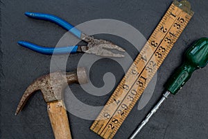 Old hammer and DIY tools on dark background