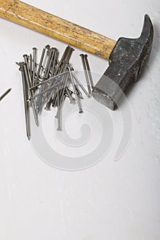 An old hammer and a handful of nails. On white background