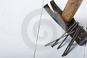 An old hammer and a handful of nails. On white background
